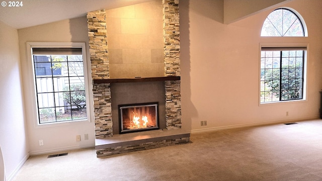 unfurnished living room featuring a fireplace, carpet floors, and lofted ceiling