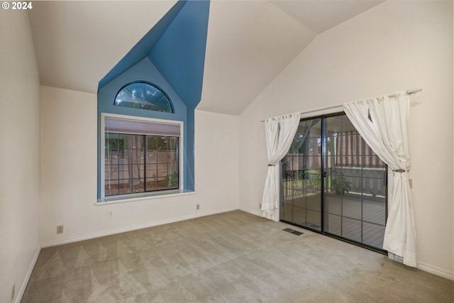 unfurnished room with light carpet and vaulted ceiling