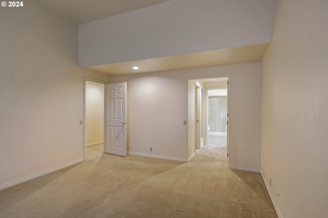 empty room featuring light colored carpet