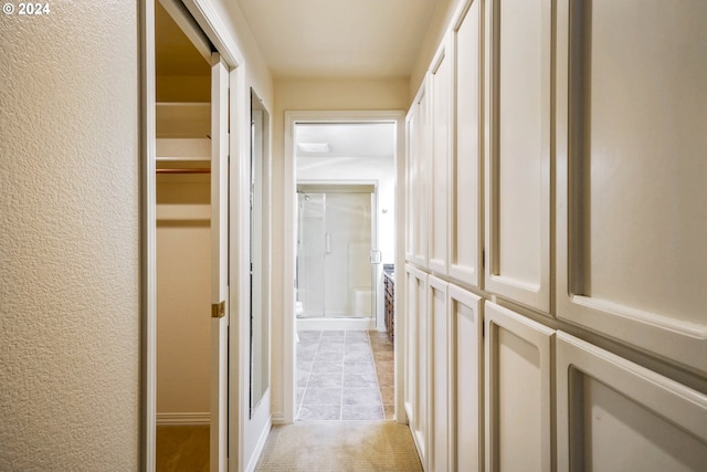 hallway featuring light tile patterned floors