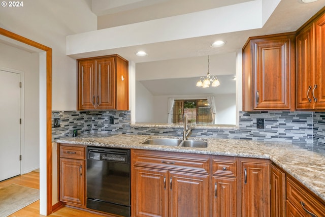 kitchen with dishwasher, sink, tasteful backsplash, a chandelier, and light hardwood / wood-style floors