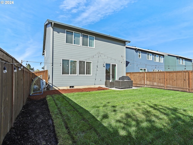 rear view of house with a patio and a yard