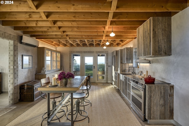 kitchen featuring a wall mounted air conditioner, concrete flooring, sink, beam ceiling, and stainless steel electric range oven