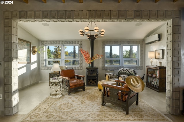 sunroom / solarium featuring a wall unit AC, a wood stove, lofted ceiling, and an inviting chandelier