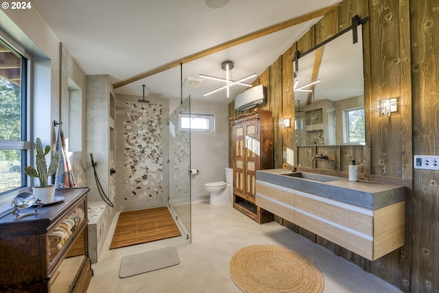 bathroom with an AC wall unit, toilet, vanity, and walk in shower