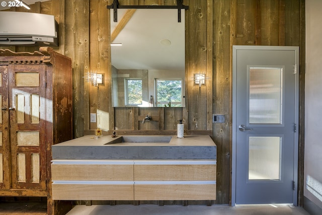 bathroom with a wall mounted air conditioner, wooden walls, and sink