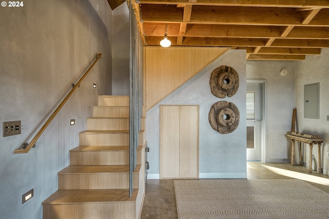 6850 SE Eola Hills Rd, Amity, OR 97101 - stairway with electric panel, beam ceiling, and concrete floors