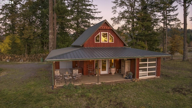 outdoor structure at dusk with a yard