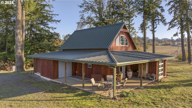 6850 SE Eola Hills Rd, Amity, OR 97101 - back of property featuring a patio area, metal roof, and a lawn