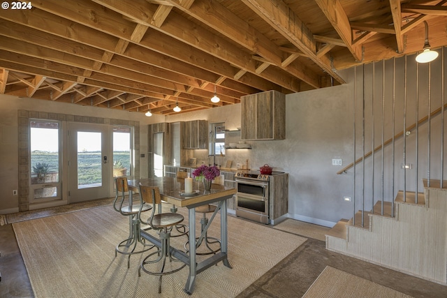 kitchen with stainless steel electric stove and decorative light fixtures