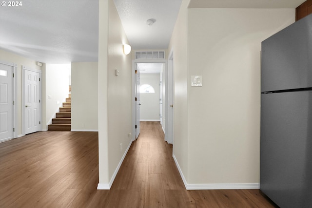 corridor featuring wood-type flooring