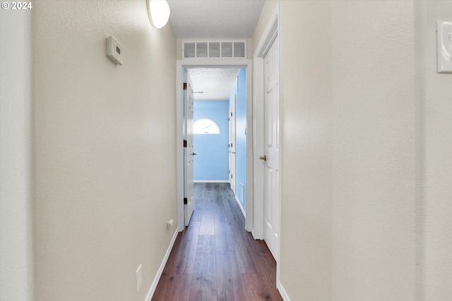 hallway with dark hardwood / wood-style floors