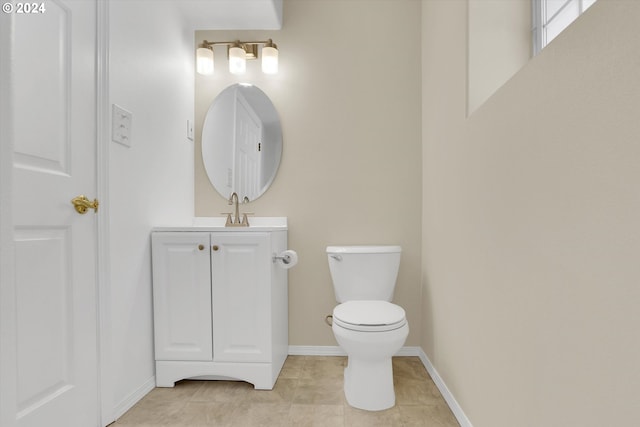 bathroom with vanity, tile patterned floors, and toilet