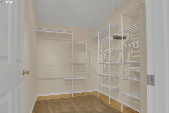 walk in closet featuring parquet floors