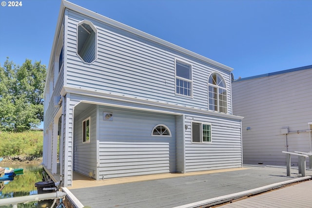 rear view of house featuring a wooden deck