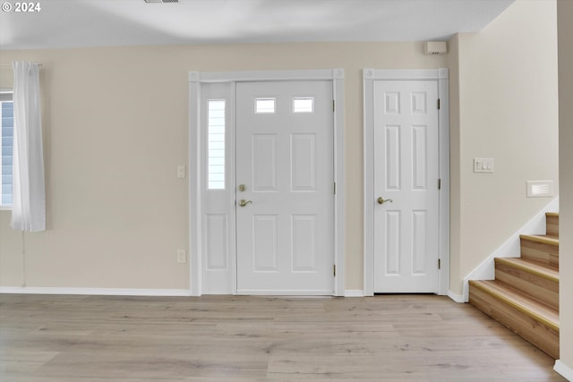 foyer entrance with light hardwood / wood-style flooring