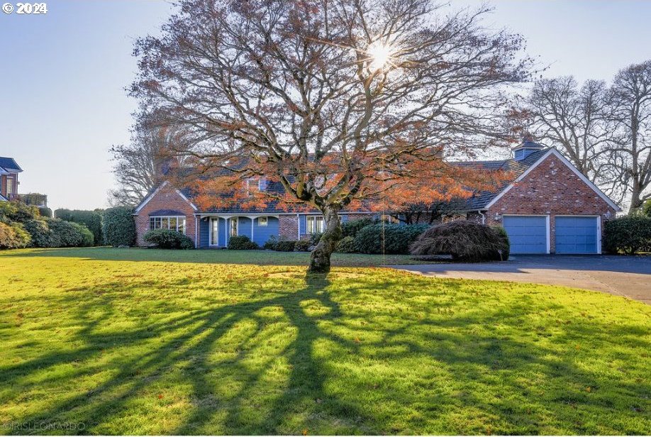 view of front of property with a garage and a front lawn