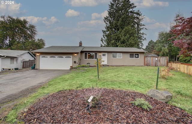 ranch-style house featuring a front yard and a garage