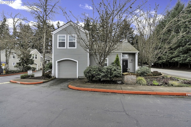 view of front of property with aphalt driveway and an attached garage