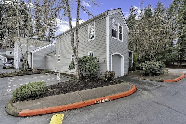 view of side of property featuring uncovered parking