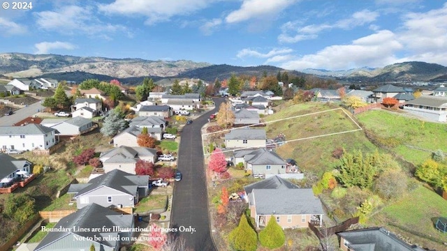 birds eye view of property featuring a mountain view