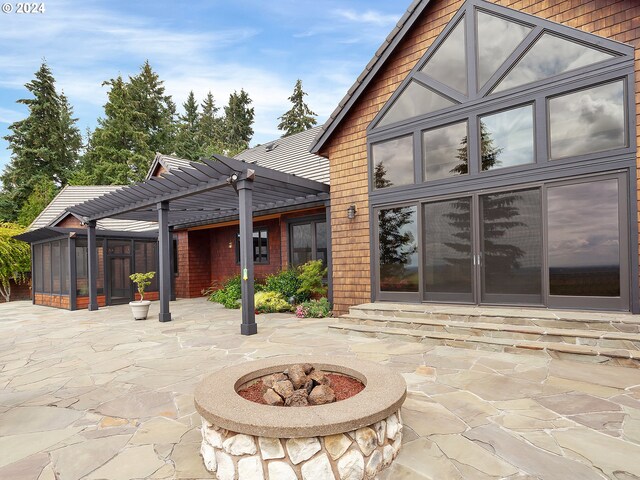 back of house featuring an outdoor fire pit, a pergola, and a patio