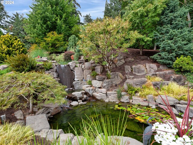 view of yard with a garden pond