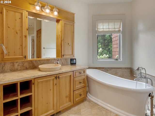 bathroom with a tub to relax in and vanity