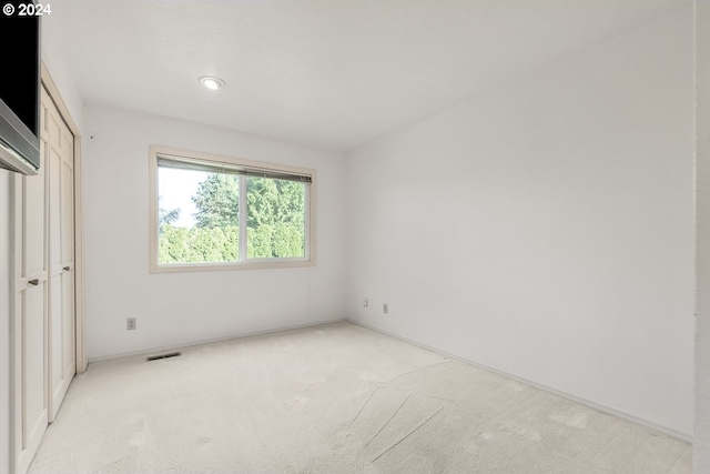 unfurnished bedroom with light carpet