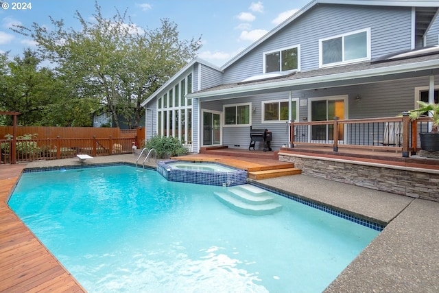 view of swimming pool featuring an in ground hot tub, a deck, and a diving board