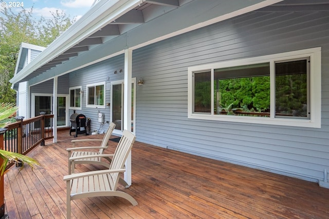 wooden deck featuring area for grilling