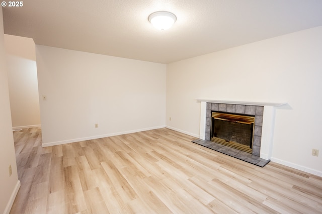 unfurnished living room with light hardwood / wood-style flooring and a fireplace
