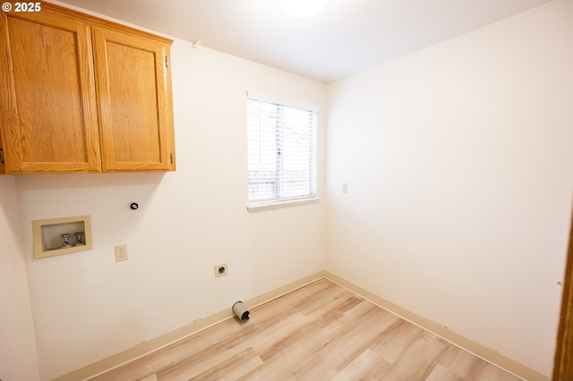 washroom featuring washer hookup, cabinets, electric dryer hookup, and light wood-type flooring