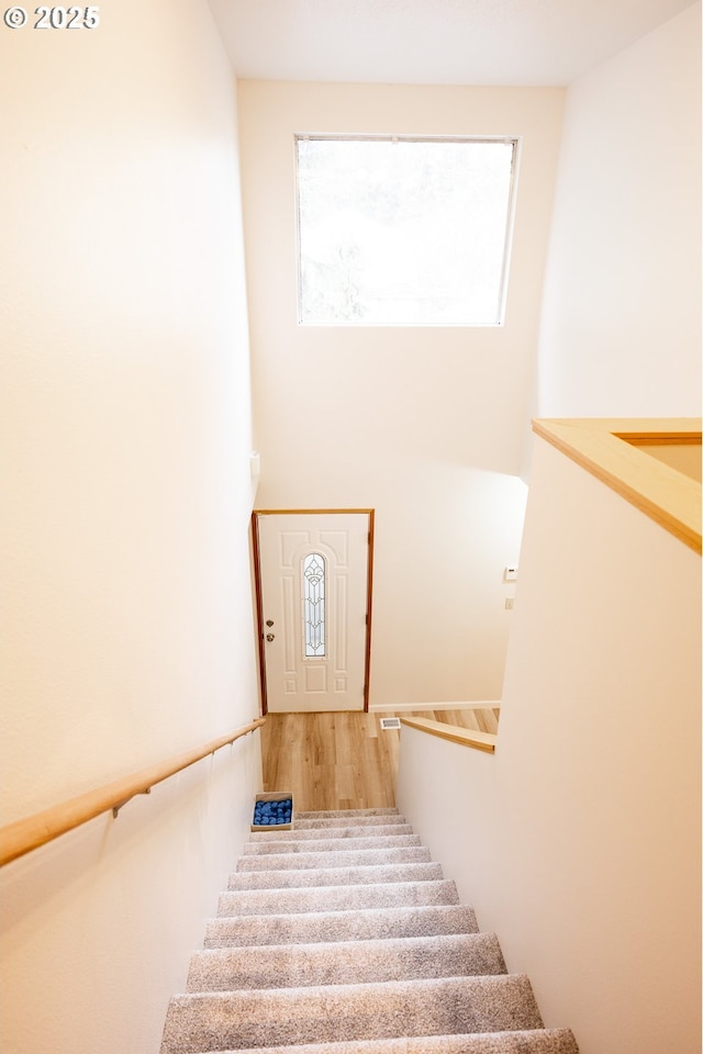 stairs with hardwood / wood-style floors