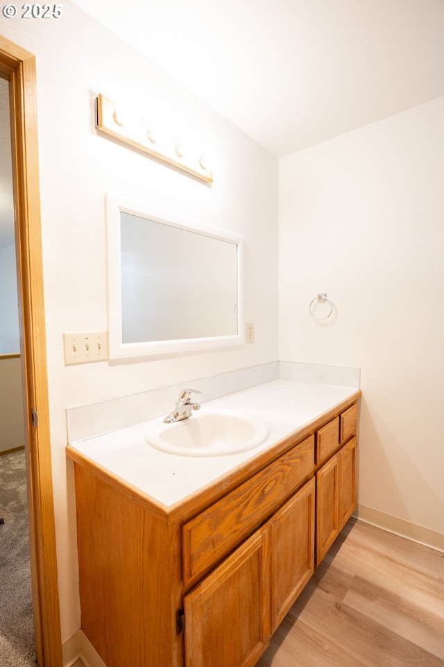 bathroom featuring vanity and wood-type flooring