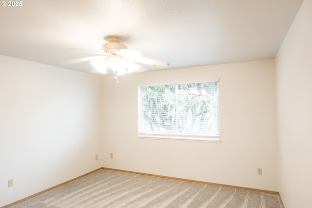 empty room featuring carpet floors and ceiling fan