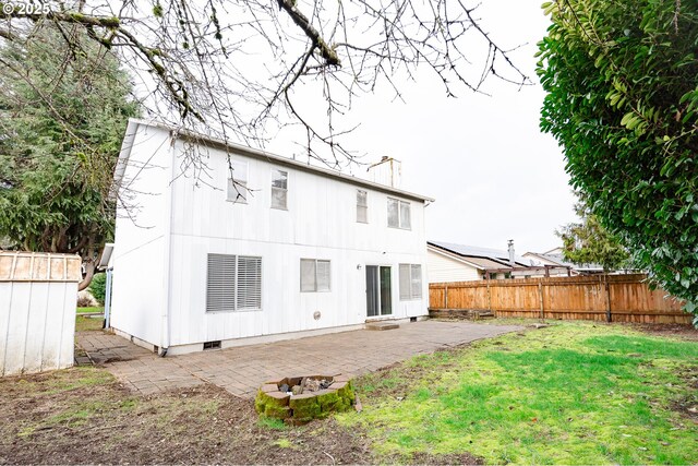 rear view of house with a lawn and a patio