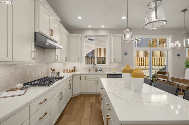 kitchen featuring white cabinetry, a kitchen island, and stainless steel appliances