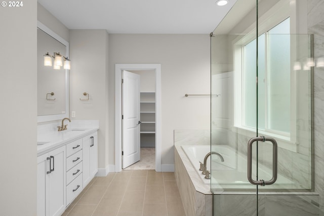 bathroom featuring tile patterned flooring, vanity, and separate shower and tub