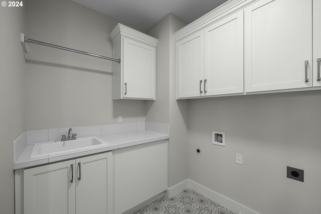 laundry room with electric dryer hookup, hookup for a washing machine, sink, and cabinets