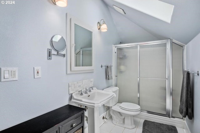 bathroom with toilet, lofted ceiling, tile patterned floors, and a shower with door