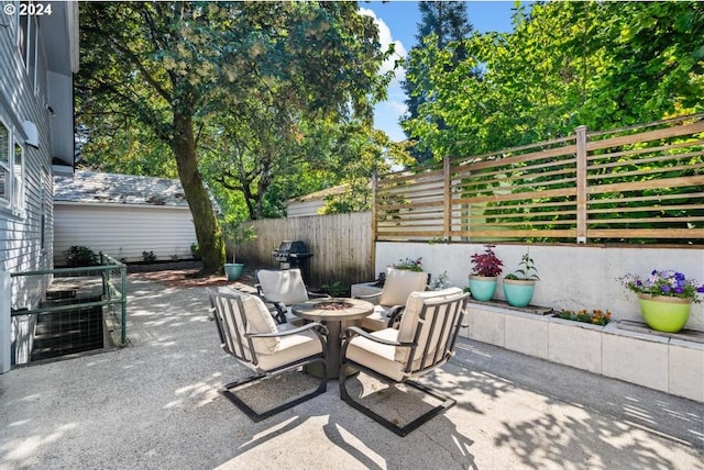 view of patio with an outdoor fire pit and area for grilling