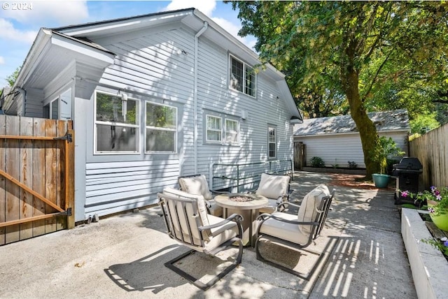 back of property featuring an outdoor fire pit and a patio area