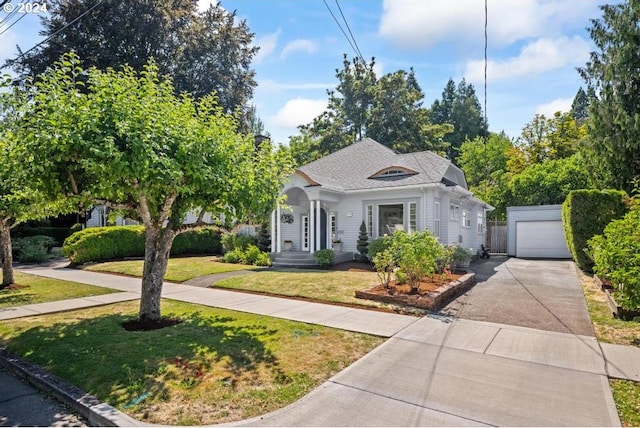 view of front of house with a front lawn, an outdoor structure, and a garage