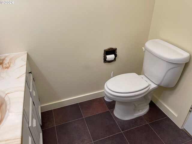 bathroom with vanity, toilet, and tile patterned floors