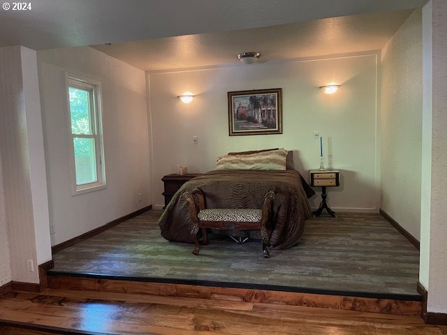 bedroom with dark hardwood / wood-style floors