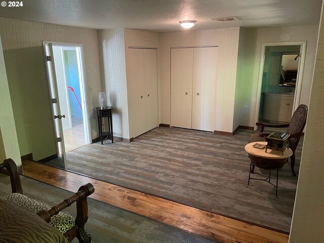 interior space featuring a textured ceiling and dark hardwood / wood-style flooring