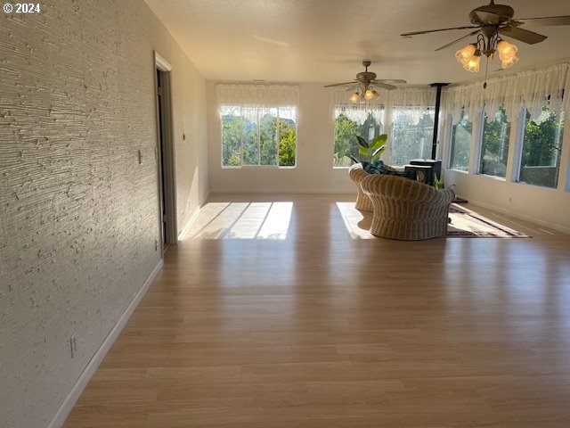 interior space with ceiling fan