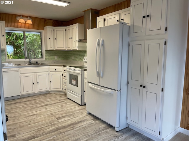 kitchen featuring sink, white cabinetry, light hardwood / wood-style flooring, white appliances, and backsplash