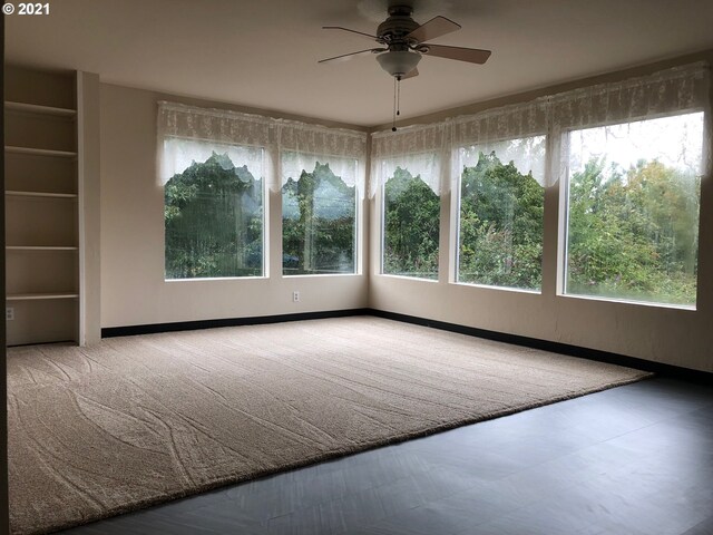 unfurnished room with ceiling fan